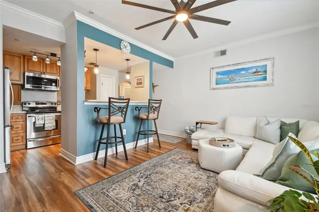 a living room with furniture and wooden floor