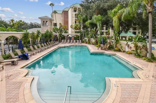 a swimming pool with outdoor seating and yard