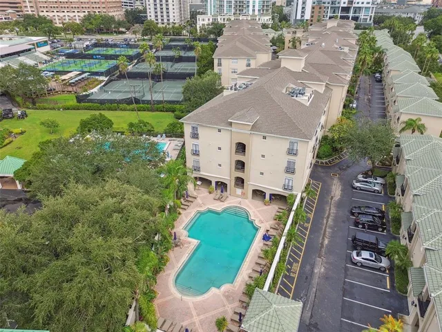 an aerial view of a house with outdoor space pool seating area and yard