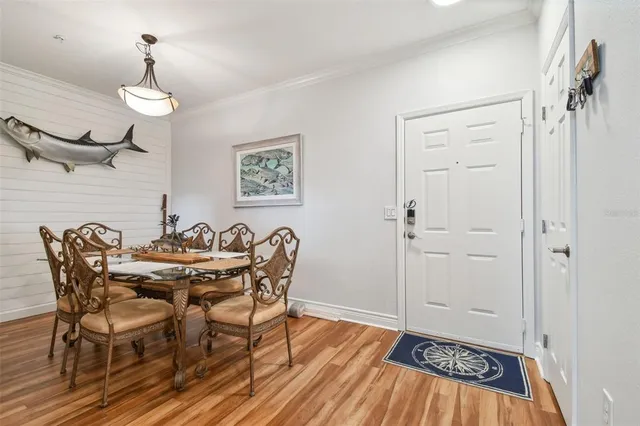 a view of a dining room with furniture wooden floor and a chandelier