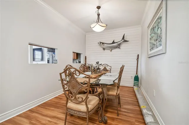 a dining room with furniture and wooden floor