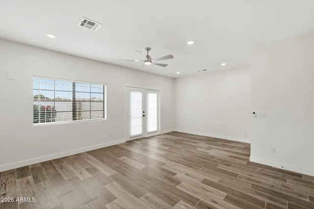 wooden floor in an empty room with a window
