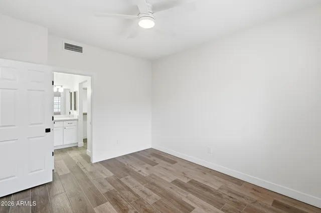 a view of empty room with wooden floor