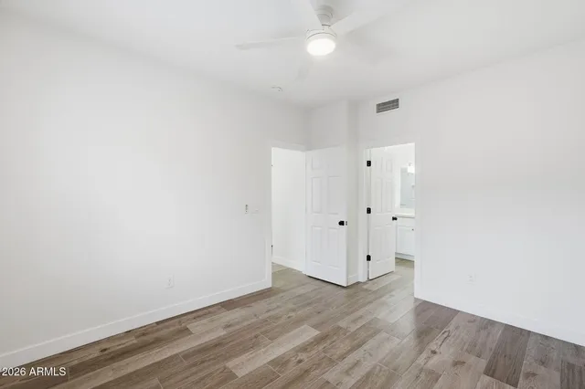 a view of an empty room with wooden floor