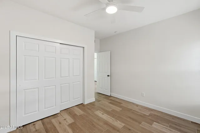 a view of an empty room and wooden floor