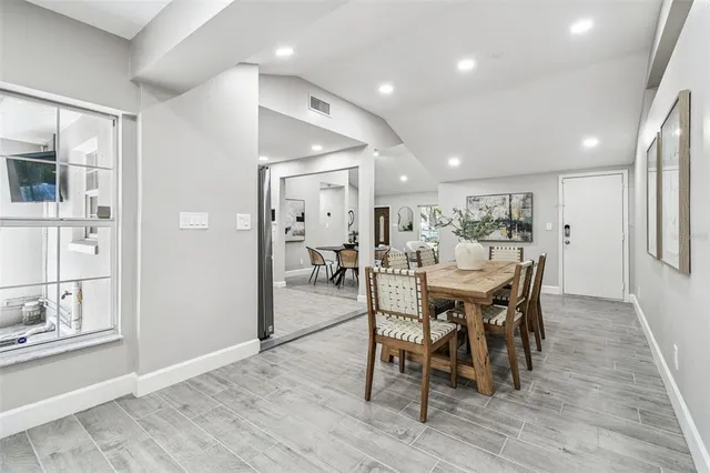 a view of a dining room with furniture and wooden floor