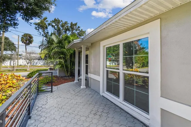 a view of a porch with furniture and garden