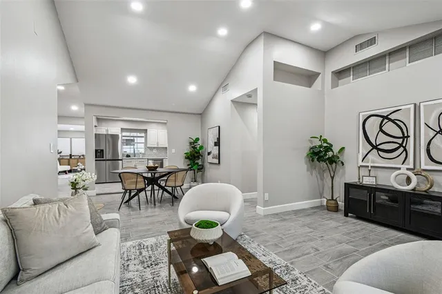 a living room with furniture potted plant and a table