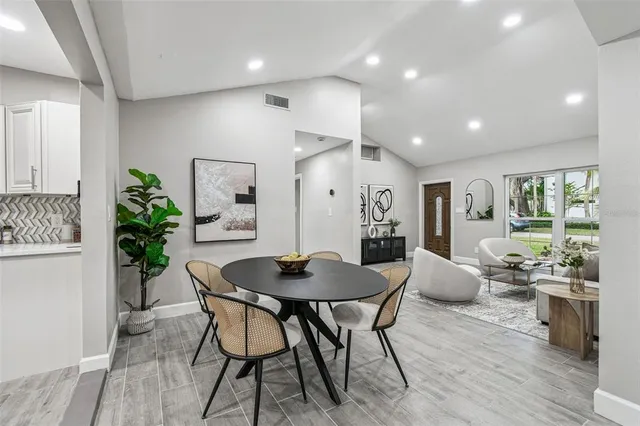 a dining room with furniture and wooden floor