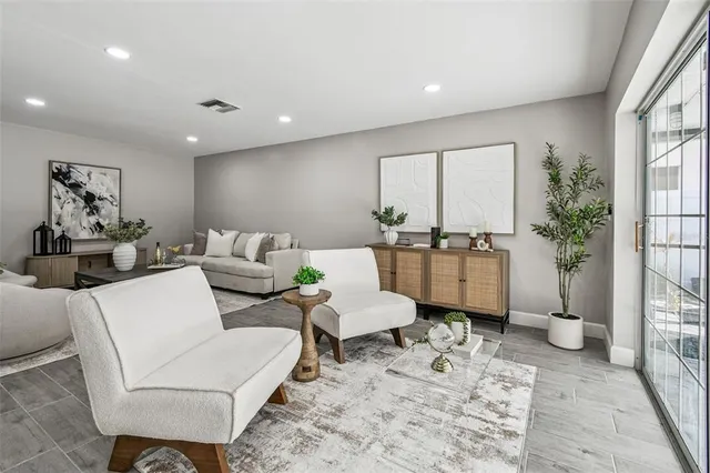 a living room with furniture and a large window