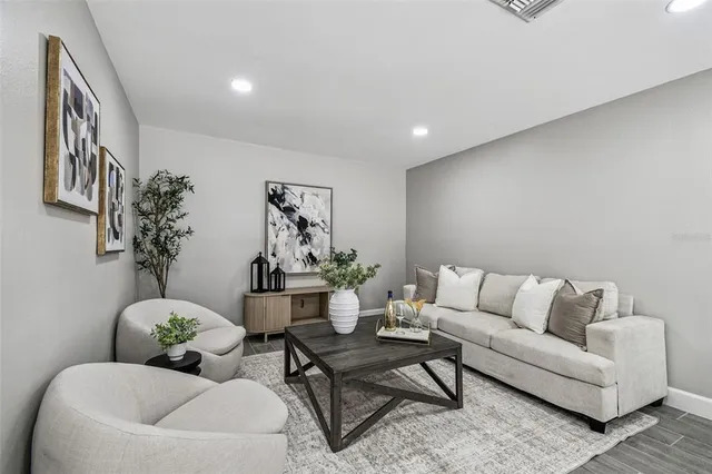 a living room with furniture and flowers