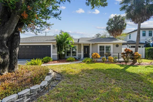 a view of a house with backyard porch and sitting area