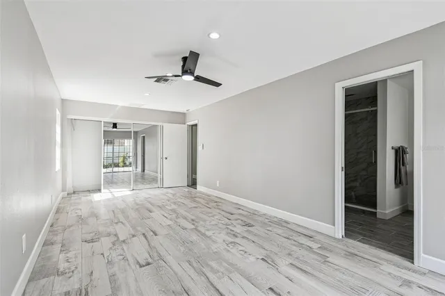 an empty room with sliding door and view of outdoor space