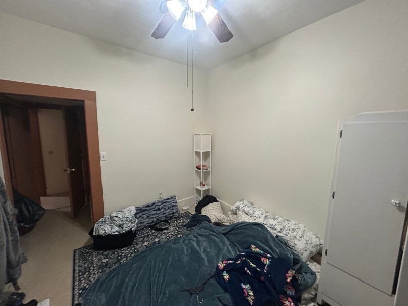 122 A Spring Street, Unit 3 Cambridge, MA 02141 - Photo 6 of 11 a bedroom with a bed and a chandelier