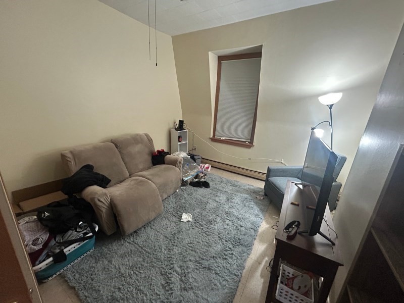 122 A Spring Street, Unit 3 Cambridge, MA 02141 - Photo 7 of 11 a living room with furniture and a mirror