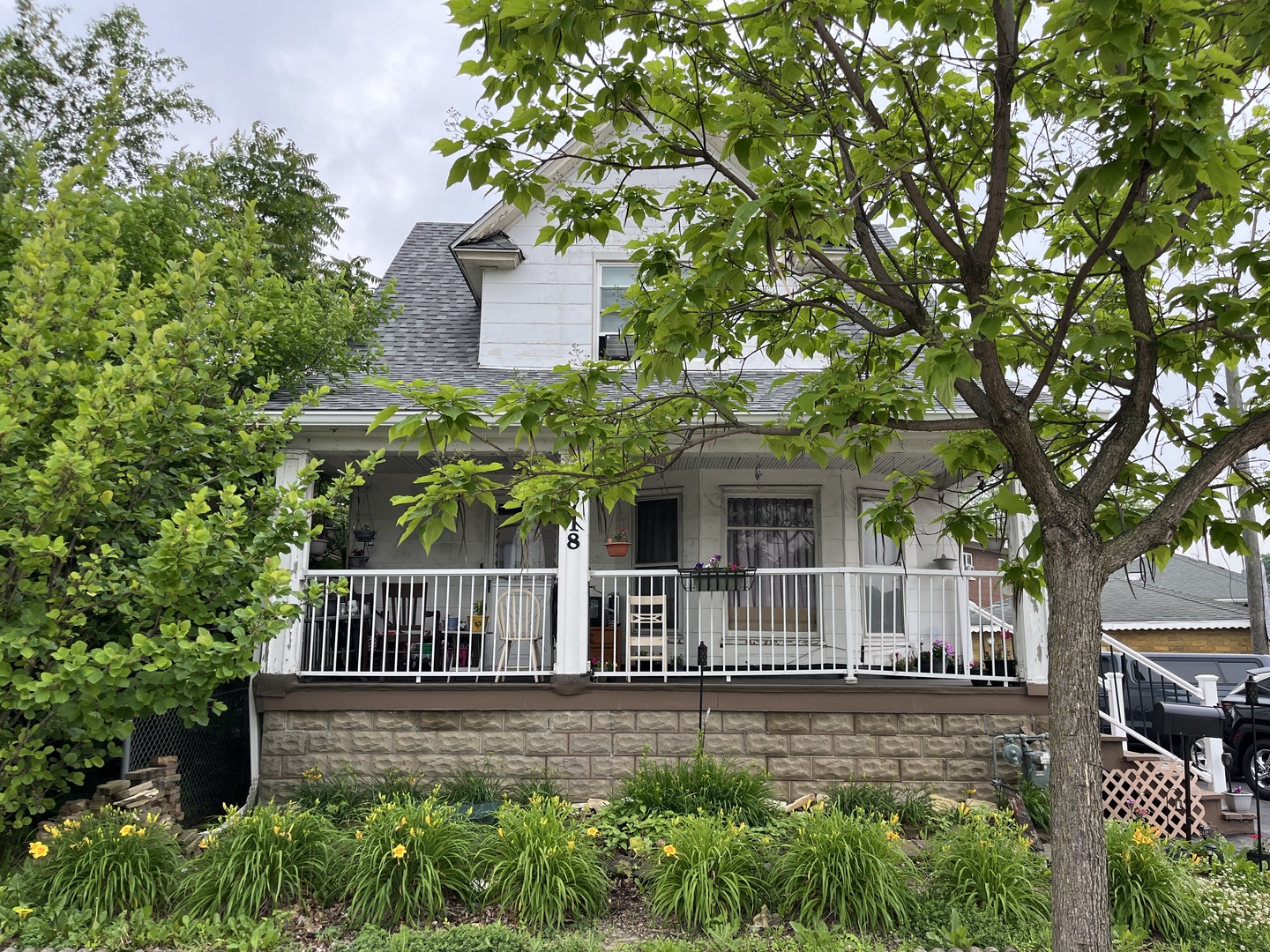 a view of a house with a small yard and wooden fence