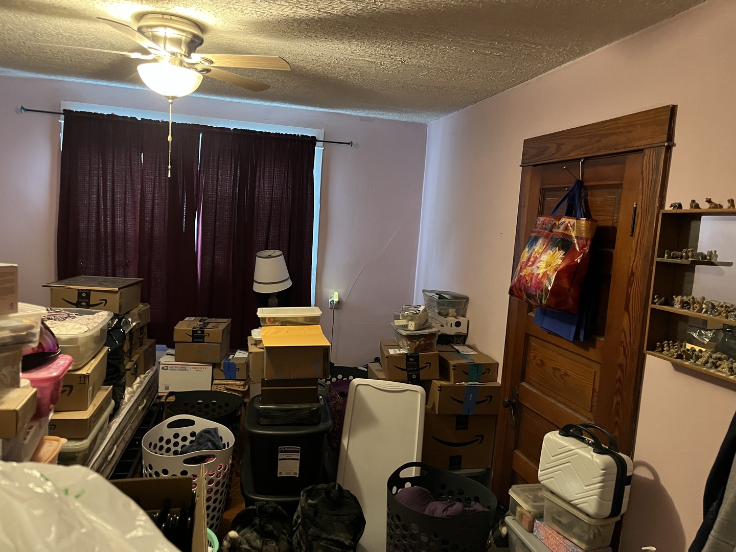 718 Plainfield Road Joliet, IL 60435 - Photo 20 of 28 a bedroom with a bed and a chandelier