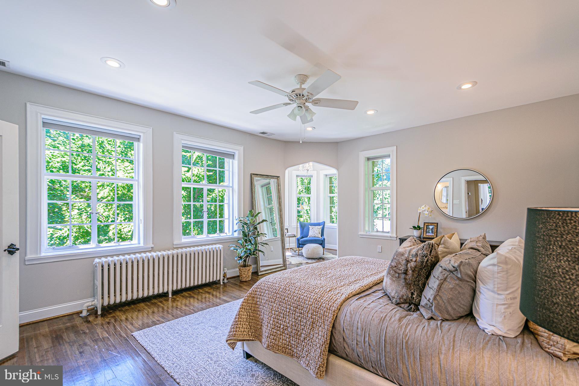 4331 Blagden Avenue Northwest Washington, DC 20011 - Photo 21 of 38 a bedroom with bed and a large window with wooden floor