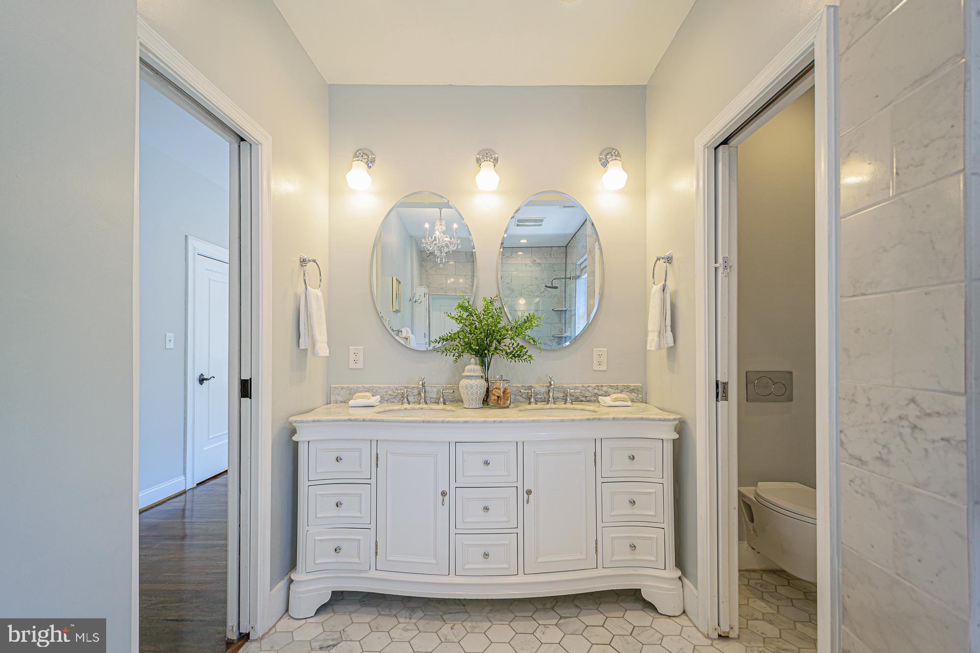 4331 Blagden Avenue Northwest Washington, DC 20011 - Photo 24 of 38 a spacious bathroom with double vanity a mirror and a shower