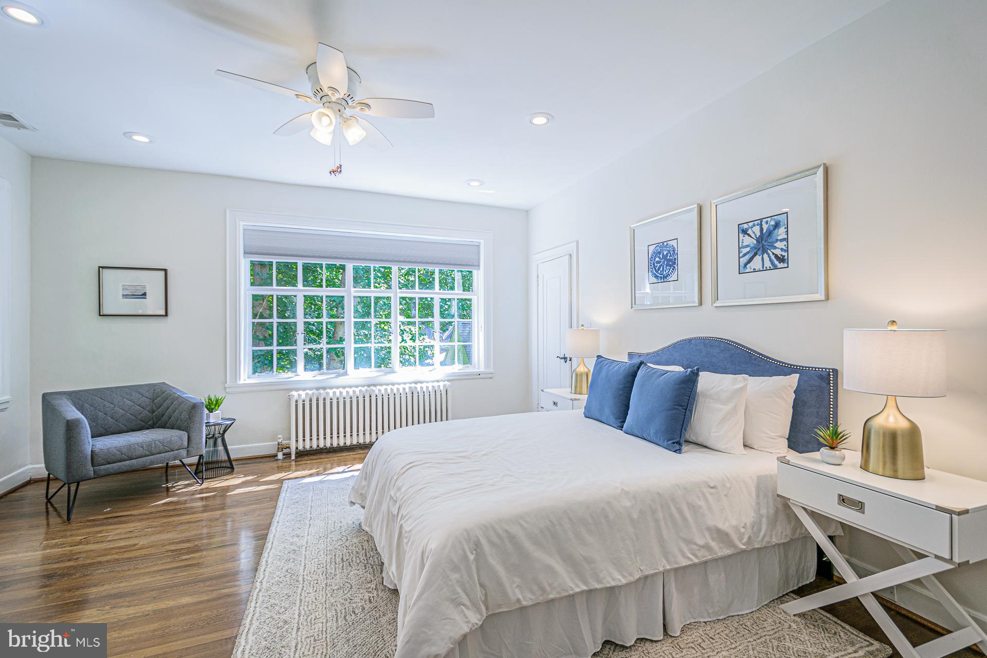 4331 Blagden Avenue Northwest Washington, DC 20011 - Photo 27 of 38 a bedroom with a bed and a chandelier