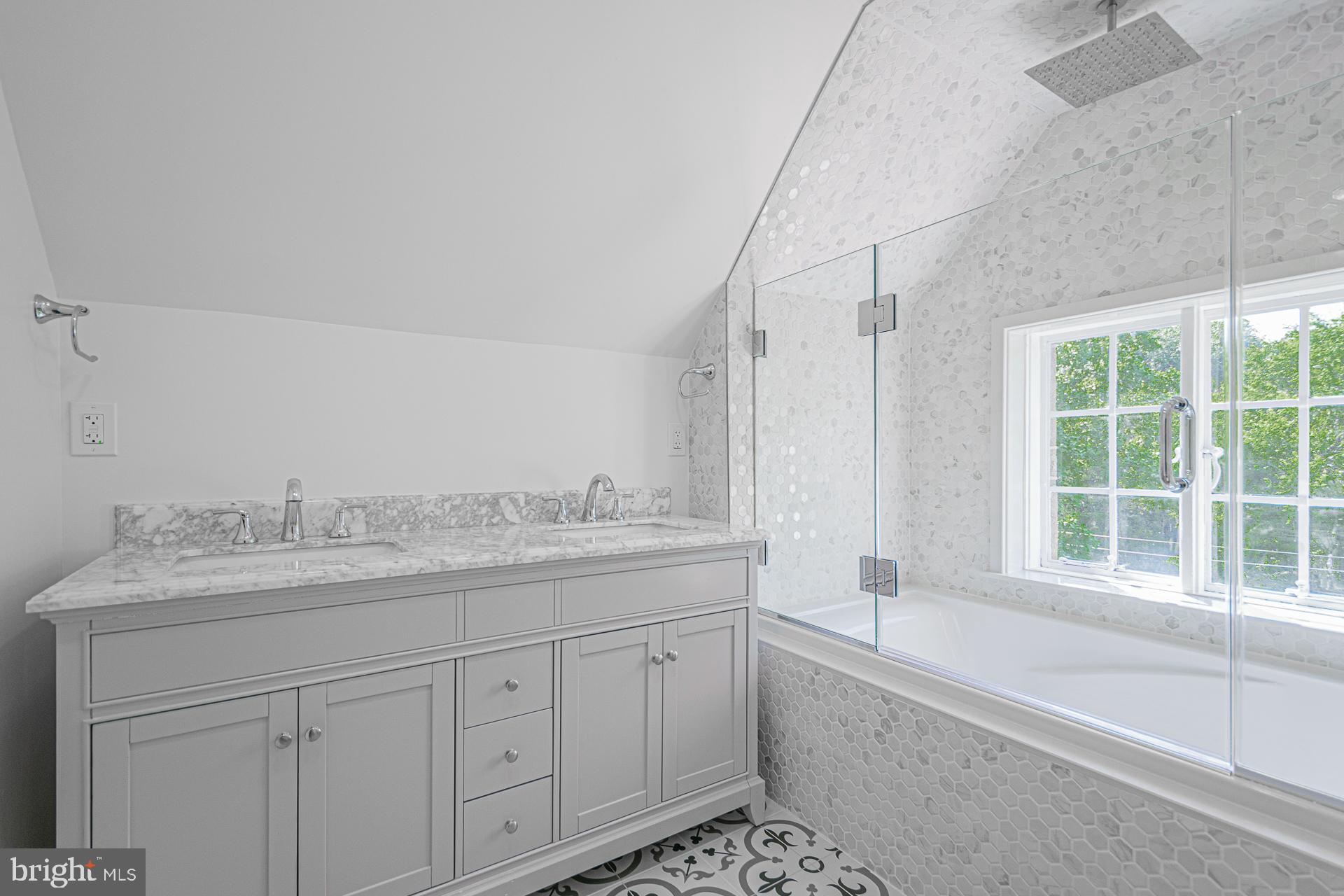 4331 Blagden Avenue Northwest Washington, DC 20011 - Photo 30 of 38 a spacious bathroom with a granite countertop sink a mirror and a bathtub