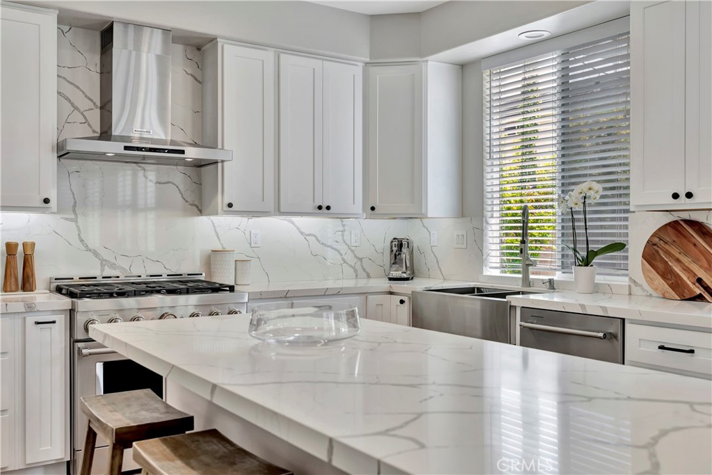 412 Mackena Place Placentia, CA 92870 - Photo 25 of 42 a kitchen with stainless steel appliances a stove a sink and white cabinets