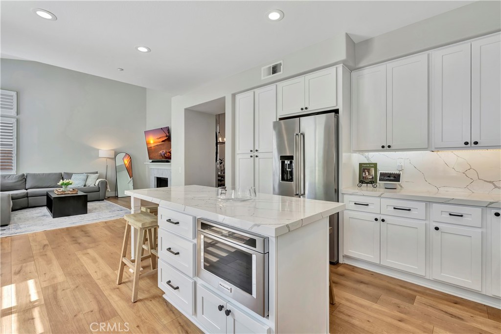 412 Mackena Place Placentia, CA 92870 - Photo 27 of 42 a kitchen with stainless steel appliances a stove a sink and a refrigerator