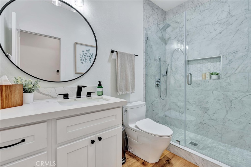 412 Mackena Place Placentia, CA 92870 - Photo 42 of 42 a bathroom with a toilet a sink and mirror