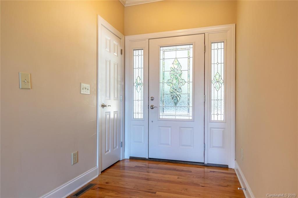 170 Towhee Trail Tryon, NC 28782 - Photo 5 of 38 a view of an empty room with wooden floor and a window