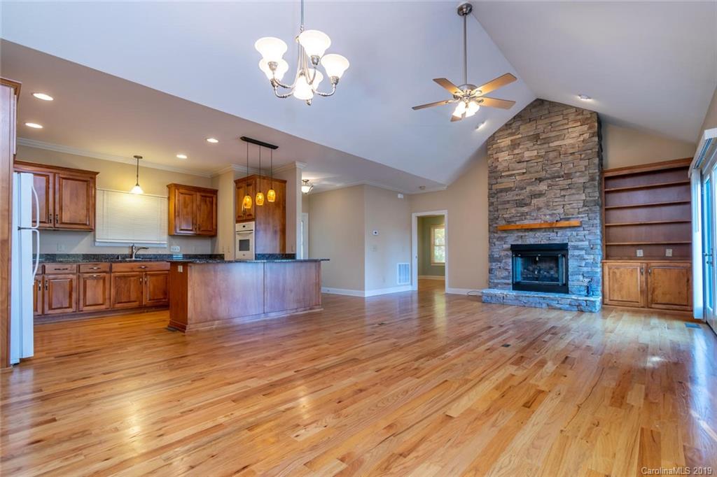 170 Towhee Trail Tryon, NC 28782 - Photo 7 of 38 an open kitchen view with fireplace and wooden floor