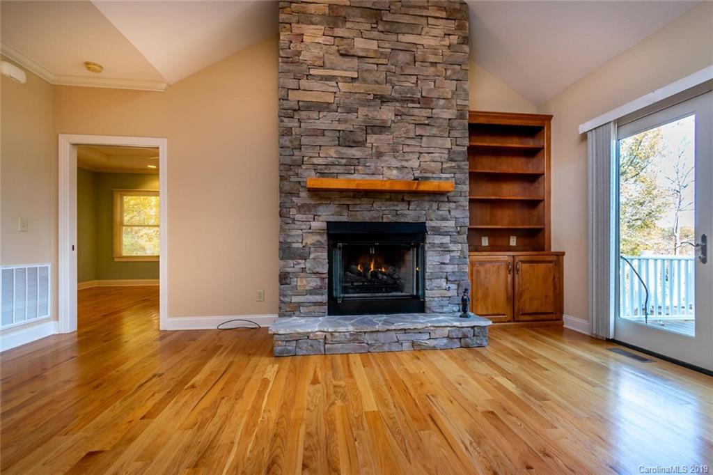 170 Towhee Trail Tryon, NC 28782 - Photo 8 of 38 a living room with a fireplace and wooden floor