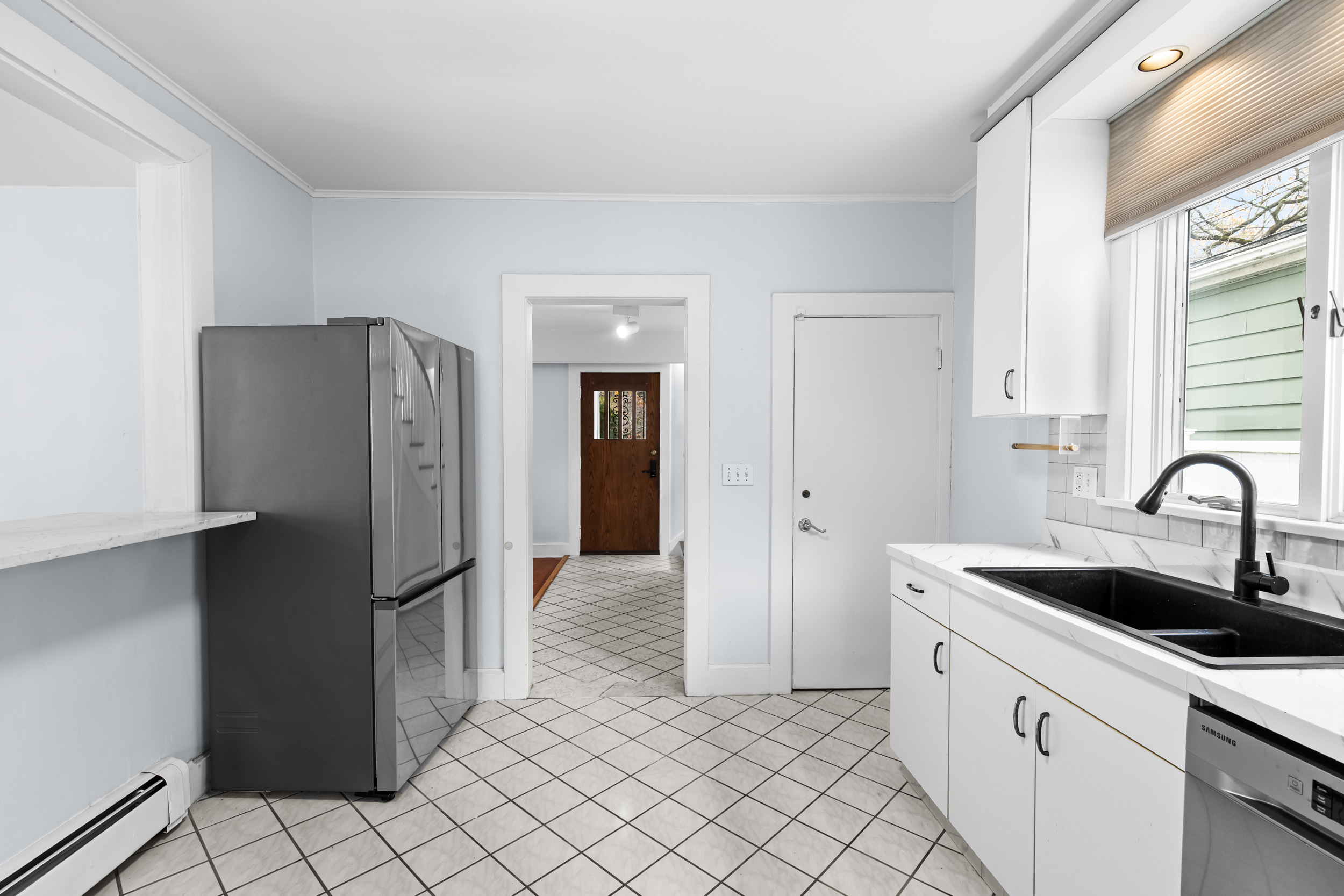 49 Valley Road Stamford, CT 06902 - Photo 13 of 37 a kitchen with a refrigerator and a sink