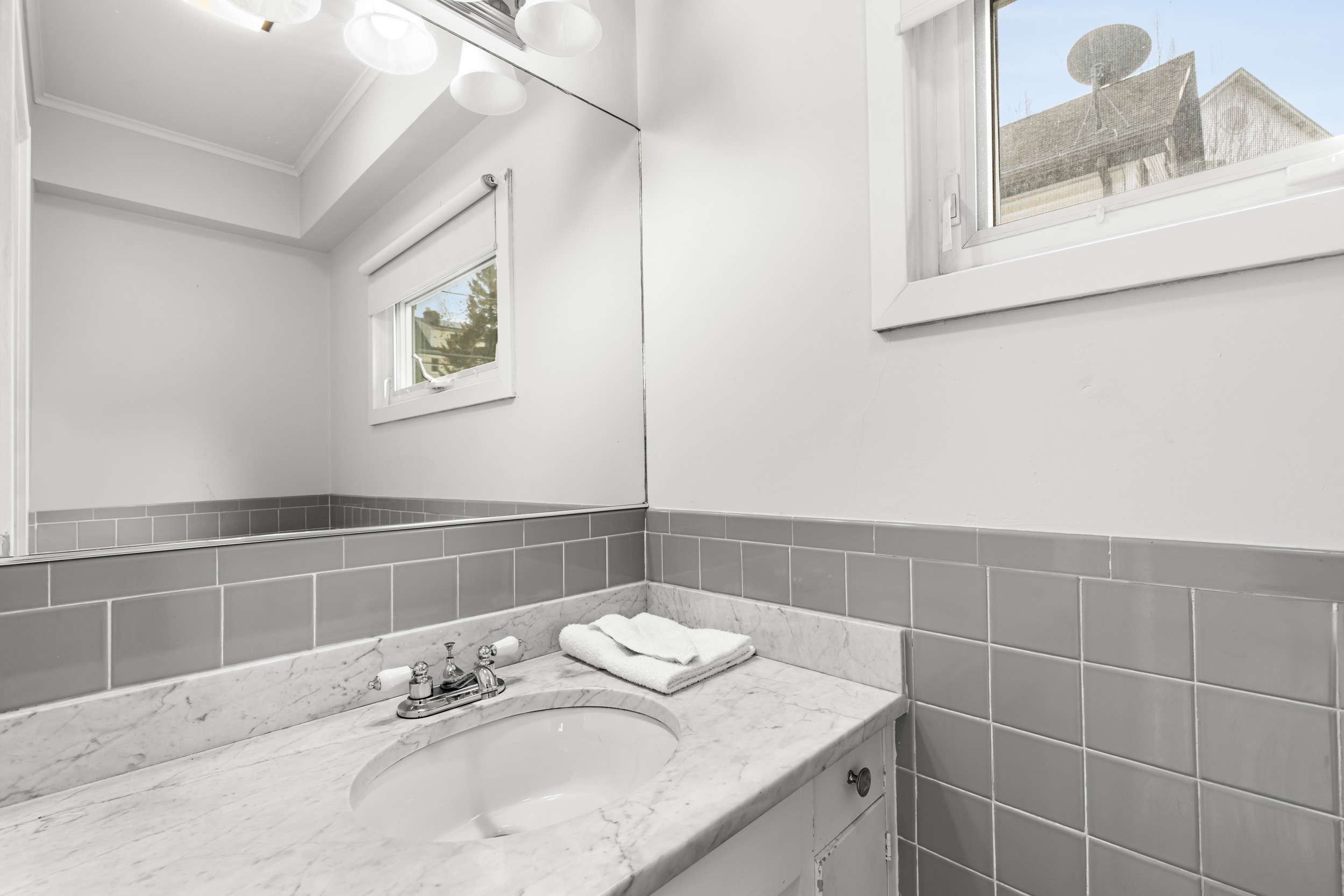 49 Valley Road Stamford, CT 06902 - Photo 15 of 37 a bathroom with a granite countertop sink and a mirror