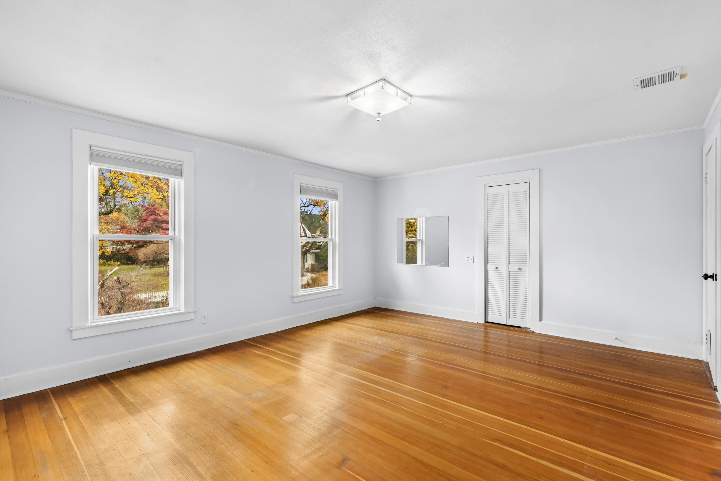 49 Valley Road Stamford, CT 06902 - Photo 17 of 37 a view of an empty room with window and wooden floor
