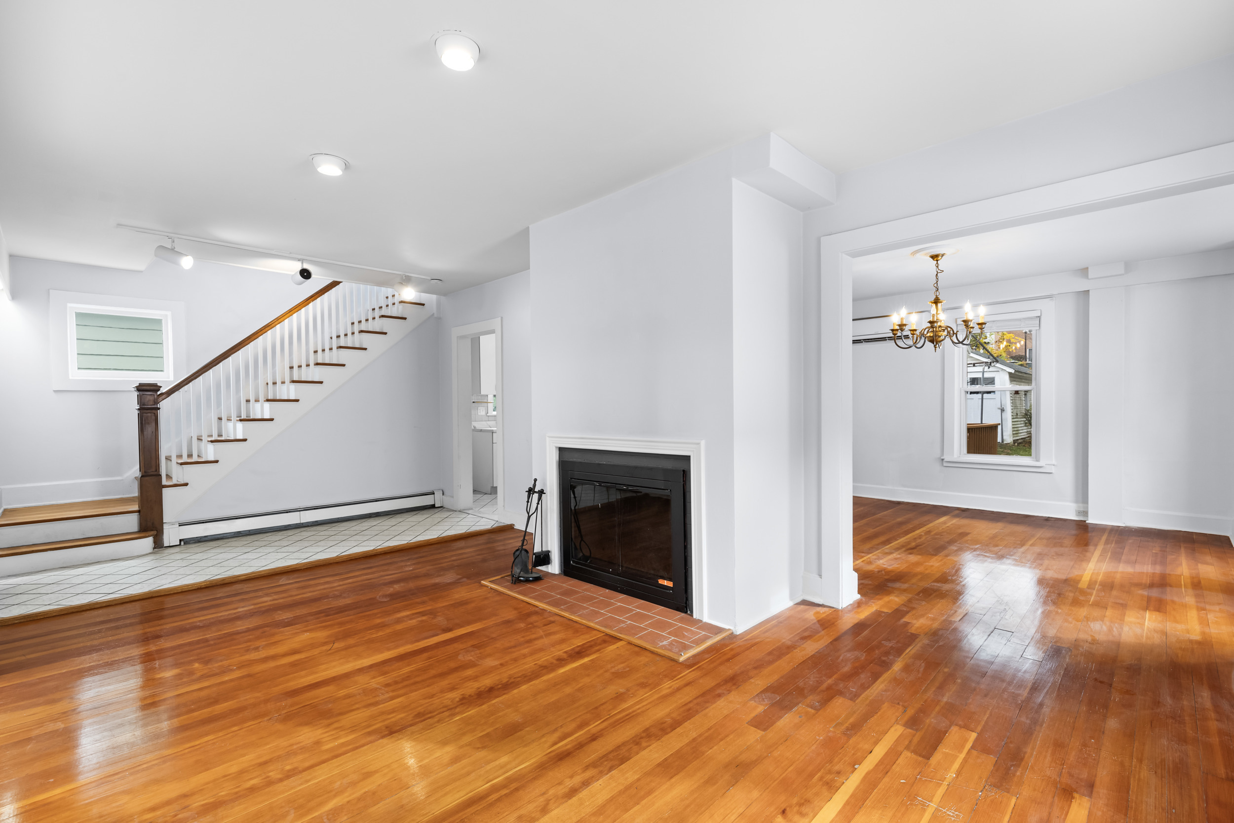 49 Valley Road Stamford, CT 06902 - Photo 5 of 37 a view of an empty room with wooden floor fireplace and a window