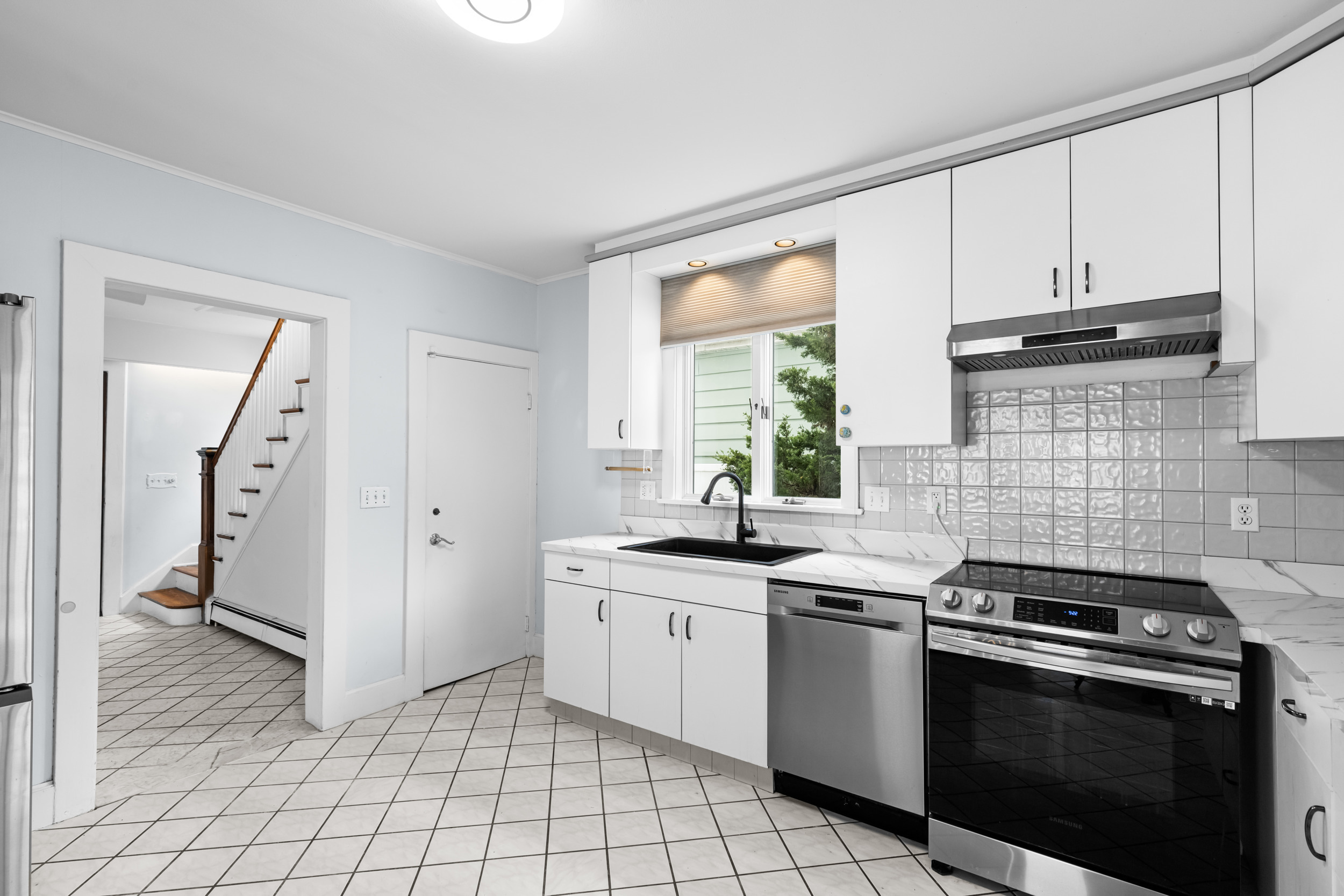 49 Valley Road Stamford, CT 06902 - Photo 10 of 37 a kitchen with a stove sink and cabinets