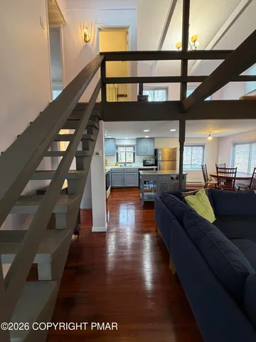 a living room with furniture or stairs and a wooden floor