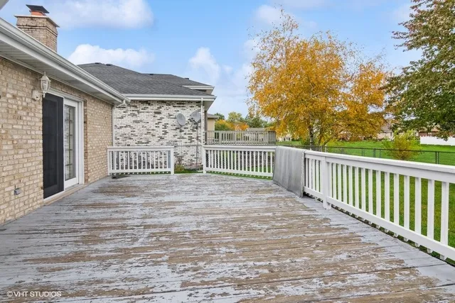 a view of a house with a wooden fence
