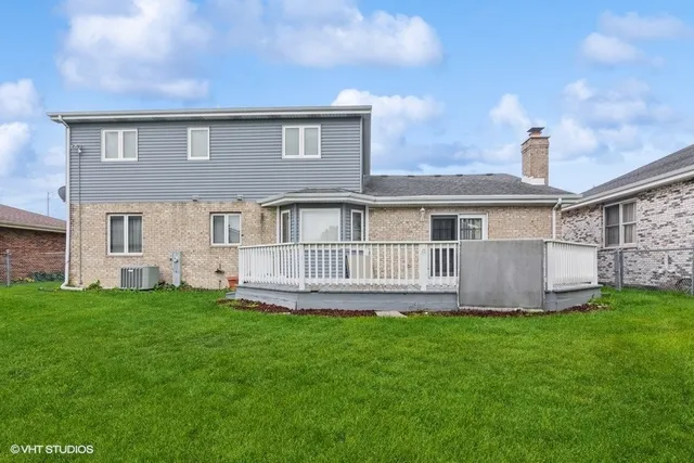 a view of a house with a yard and a porch