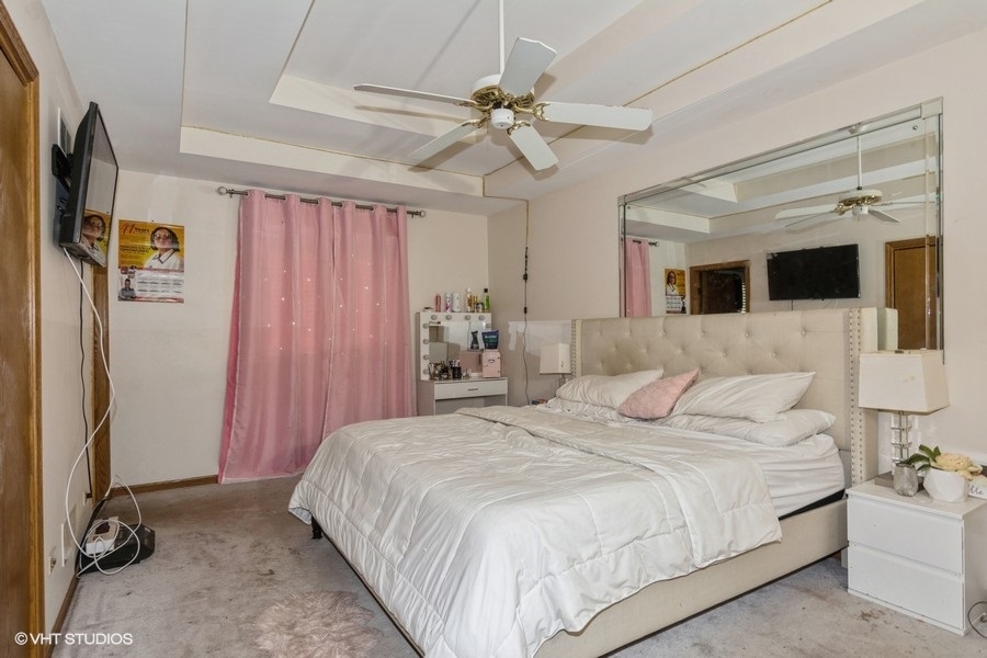 19265 Lange Street Lansing, IL 60438 - Photo 8 of 18 a bedroom with a large bed and a window