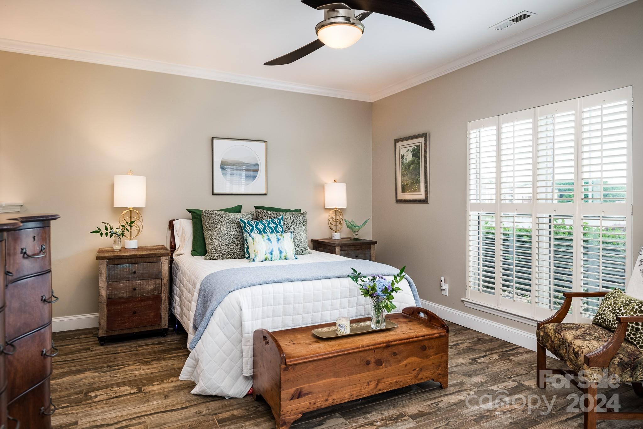 860 Jetton Street, Unit 64 Davidson, NC 28036 - Photo 16 of 33 a bedroom with a bed and wooden floor