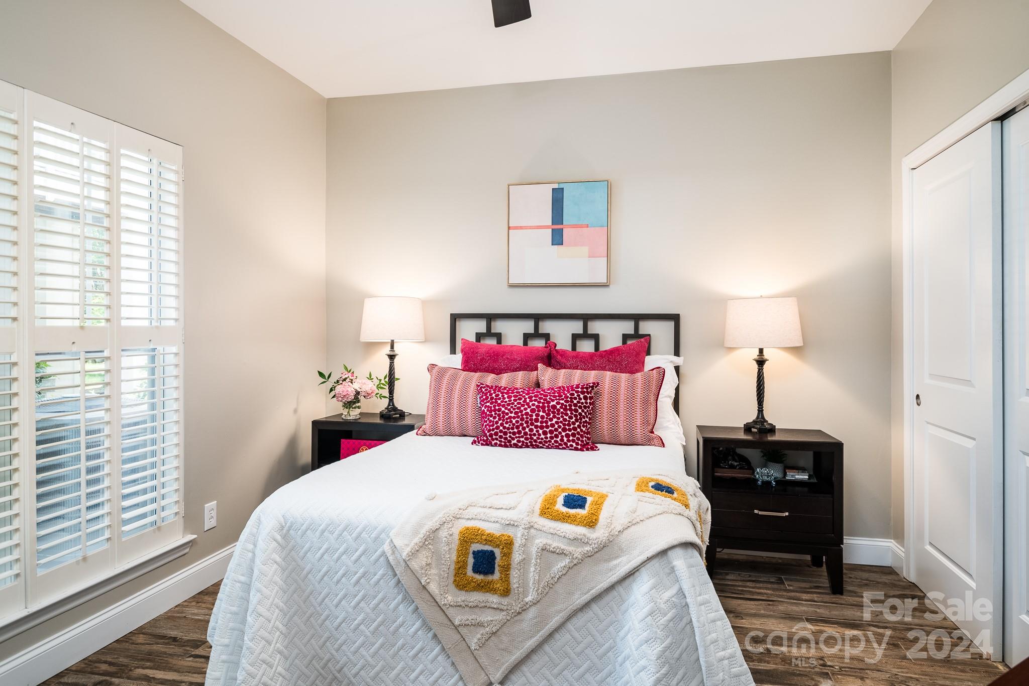 860 Jetton Street, Unit 64 Davidson, NC 28036 - Photo 22 of 33 a bedroom with a bed and a lamp on the dresser