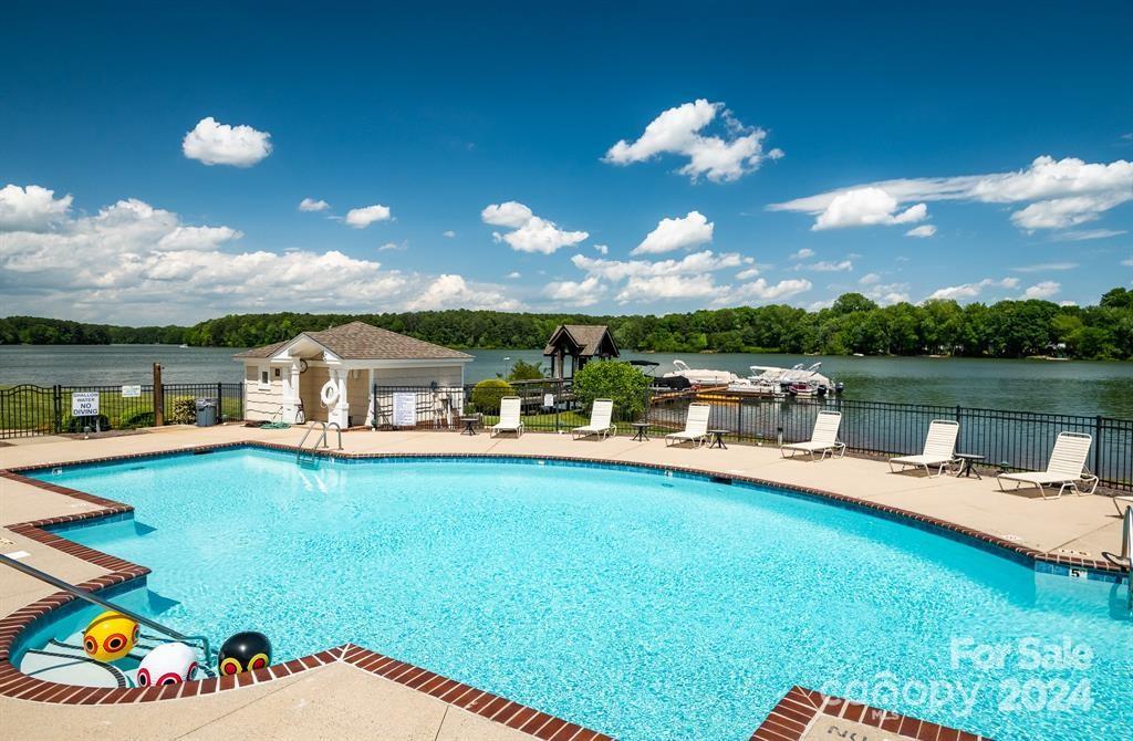 860 Jetton Street, Unit 64 Davidson, NC 28036 - Photo 29 of 33 a view of a house with swimming pool and a yard