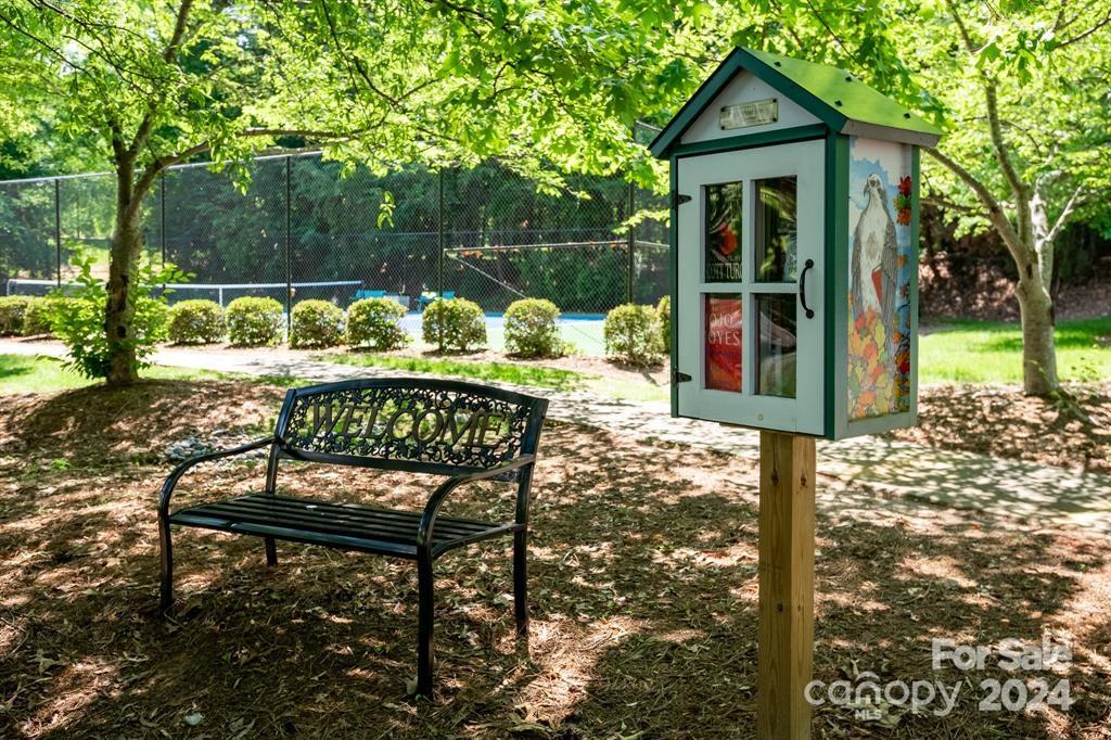 860 Jetton Street, Unit 64 Davidson, NC 28036 - Photo 33 of 33 a wooden bench sitting in front of a house