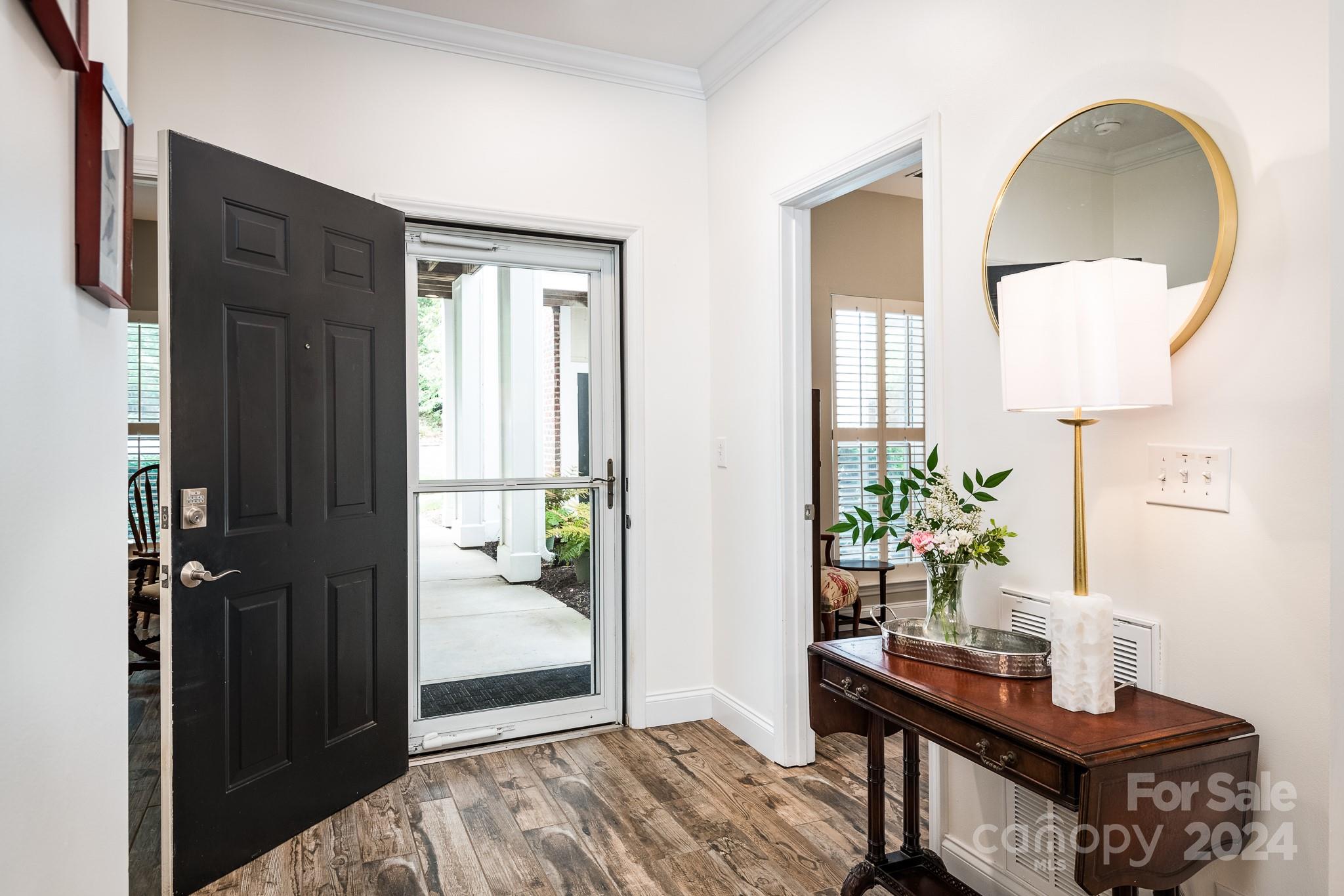 860 Jetton Street, Unit 64 Davidson, NC 28036 - Photo 8 of 33 a bedroom with a bed table and a lamp