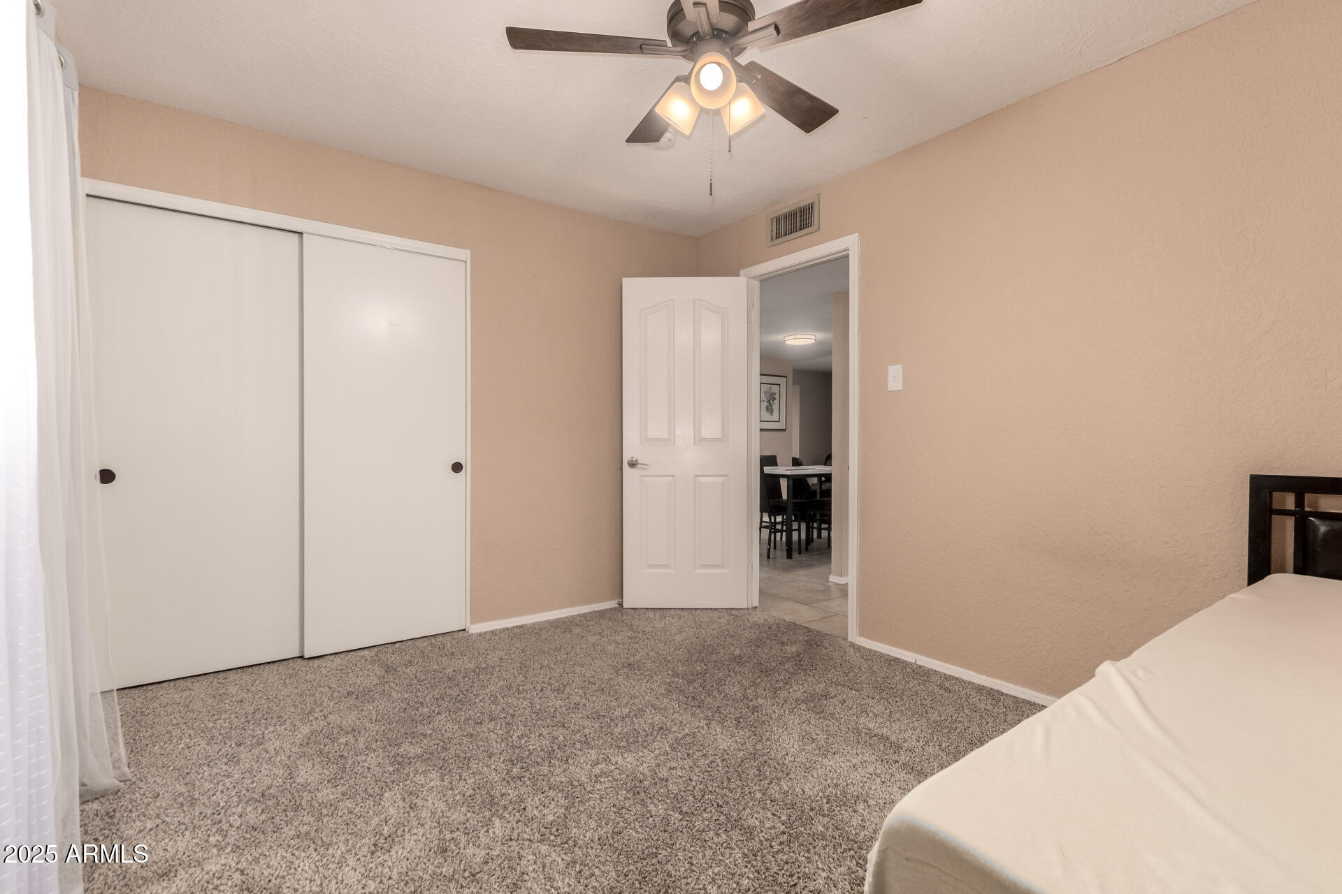 3529 West St Moritz Lane Phoenix, AZ 85053 - Photo 22 of 34 a view of empty room with wooden floor and ceiling fan