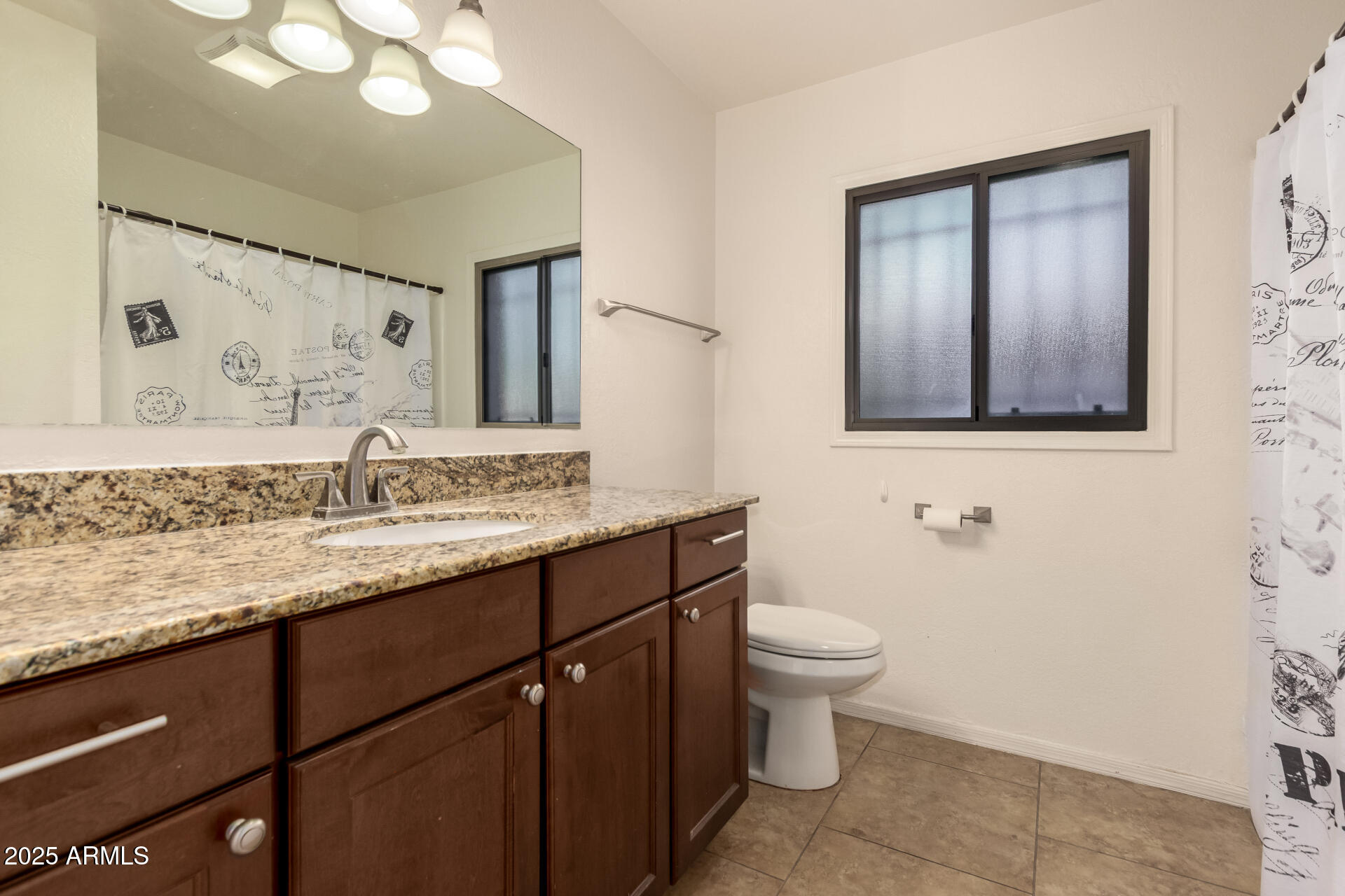 3529 West St Moritz Lane Phoenix, AZ 85053 - Photo 25 of 34 a bathroom with a granite countertop sink a toilet and mirror