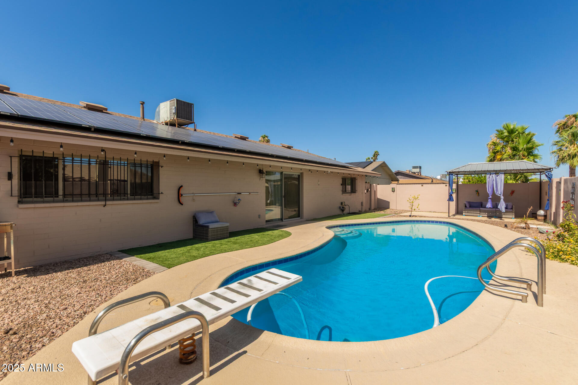 3529 West St Moritz Lane Phoenix, AZ 85053 - Photo 30 of 34 a view of a swimming pool with a lounge chairs