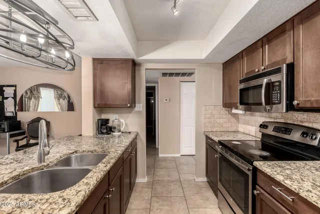 a kitchen with a sink stove and microwave