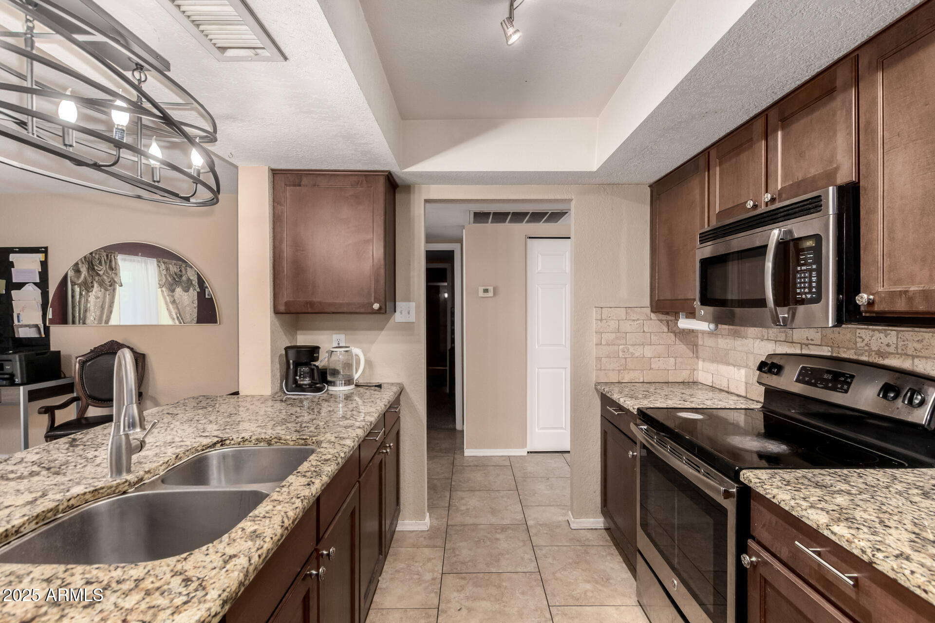 3529 West St Moritz Lane Phoenix, AZ 85053 - Photo 5 of 34 a kitchen with a sink stove and microwave